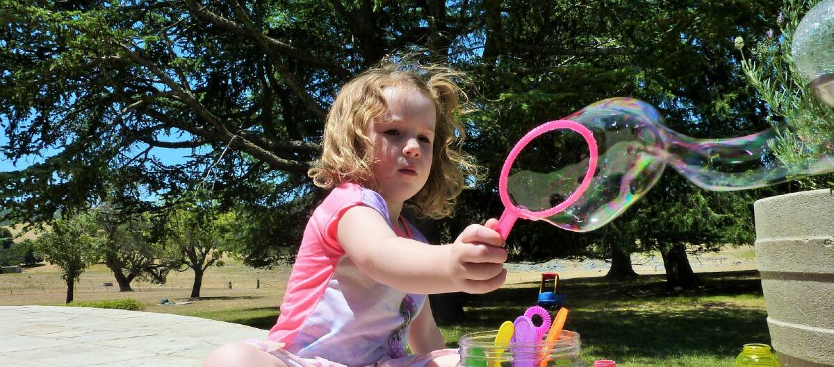 Ducks 'n' Fishes is one of the most kid-friendly cafes you'll find in our region. Here Emily, Tim's daughter, blows bubbles on the cafe deck. Photo: Tim the Yowie Man
