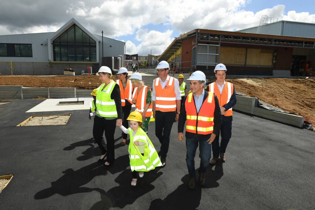 Daniel Andrews (centre)  Deputy Premier James Merlino (second from right) tour the new Pakenham Primary School on Wednesday. Photo: AAP