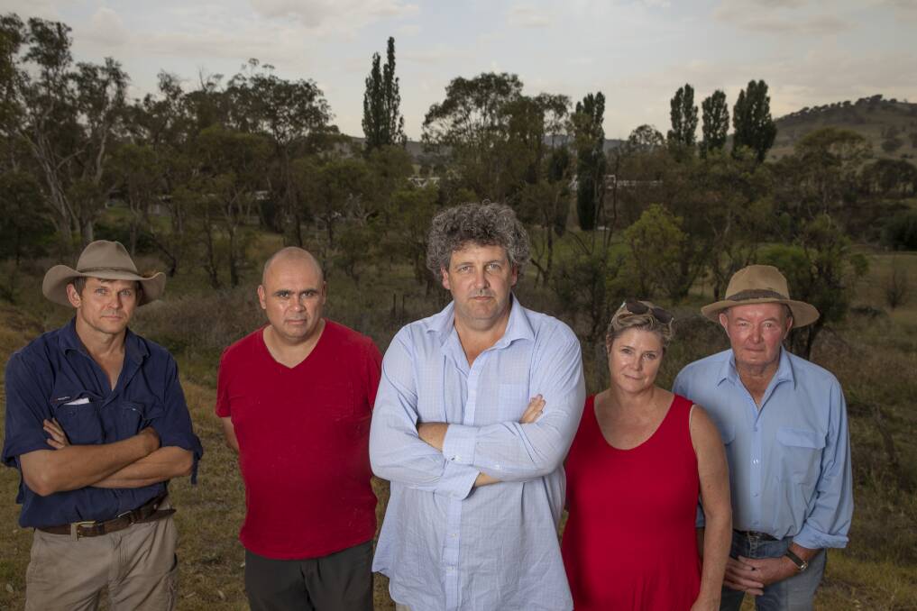 Tharwa residents, from left, Myles Gostelow, Karim Haddad, Kevin Jeffery, Janet Flint and Michael Lonergan stand near the site of a proposed firefighting water supply on the Murrumbidgee River which they say won't serve the village's needs. Photo: Sitthixay Ditthavong