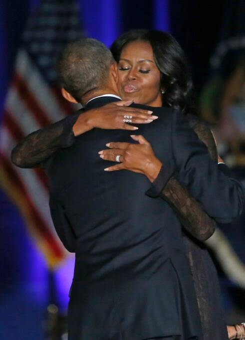 First Lady Michelle Obama hugs her husband Barack after his address. Photo: Charles Rex Arbogast