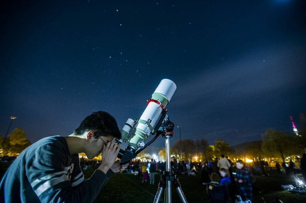 Belconnen's Blasius Kim, 18, spotted Saturn as onlookers gathered to break a stargazing world record.


 21 August 2015
Photo: Rohan Thomson
The Canberra Times Photo: Rohan Thomson