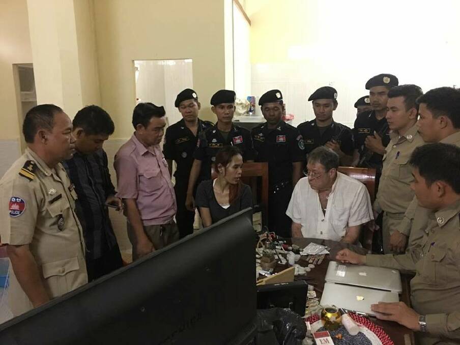 Gary Knowles at his arrest. Cambodian papers said the woman was his girlfriend.  Photo: Cambodian police