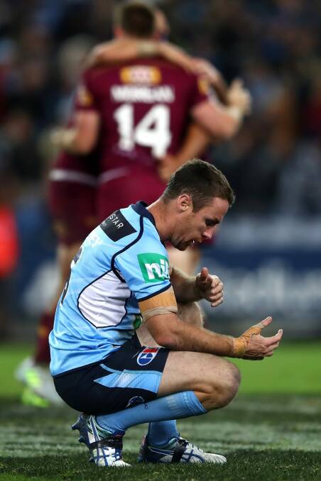 Gutted: James Maloney crouches over in dejection after the final whistle. Photo: Getty Images