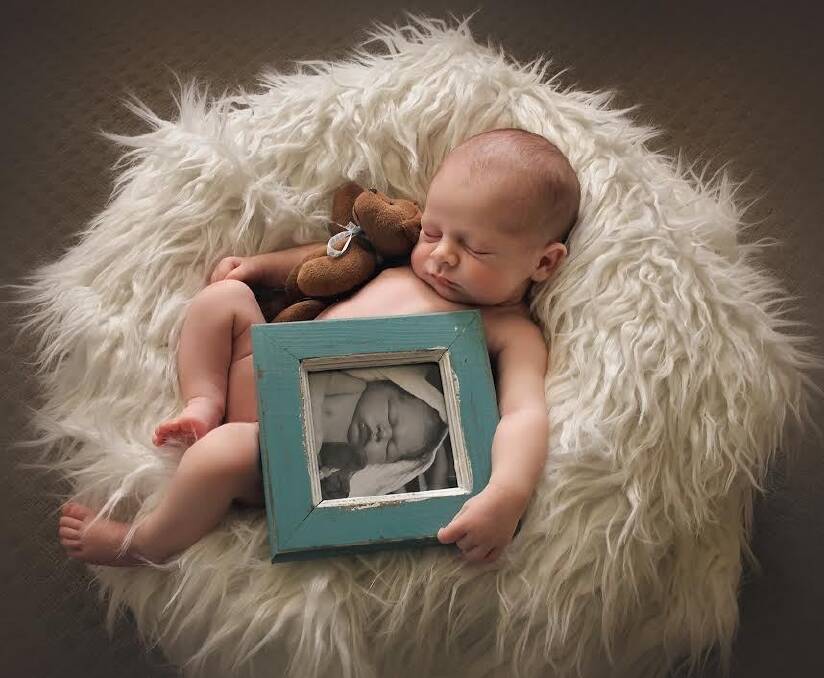 Isobel Carroll with a framed photo of her brother Samuel, who died before she was born.  Photo: Kelly Gladwin