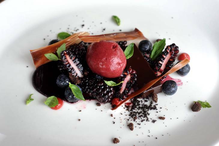 Dark chocolate ganache, fresh karakaberries and blueberries, mulberry and basil sorbet at The    Aubergine Restaurant at Griffith. Photo: Richard Briggs