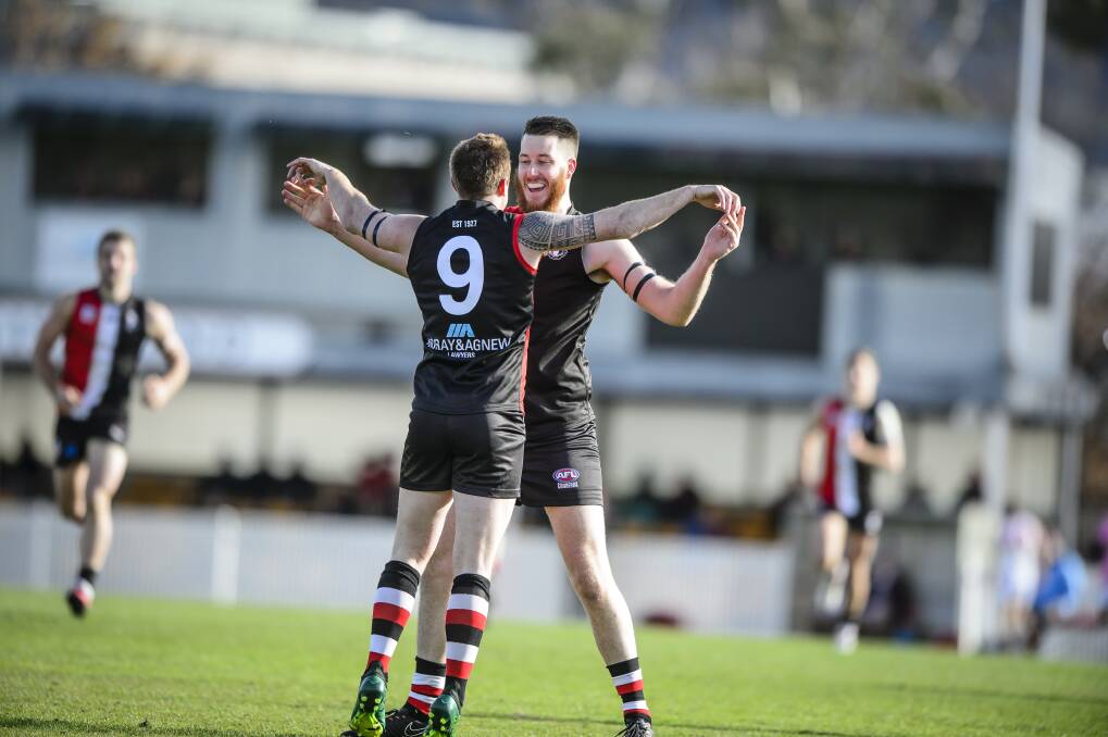 Ainslie's Aaron Wiles celebrates with Hayden Armstrong after kicking a goal. Photo: Sitthixay Ditthavong