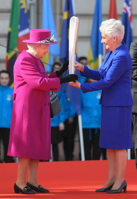 Queen Elizabeth II, left, holds the relay baton with Louise Martin, the President of the Commonwealth Games Federation, at the launch of The Queen's Baton Relay for the XXI Commonwealth Games being held in the Gold Coast. Photo: TOBY MELVILLE
