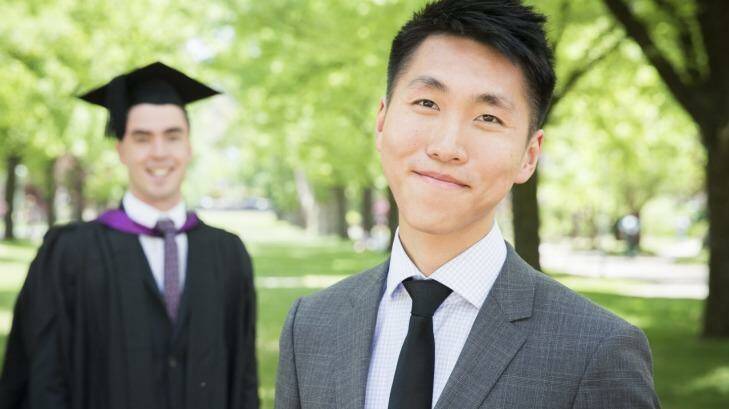 Cut-price: From left, Dallas Proctor, who will graduate this year, and UniGowns co-founder Eric Liu at the Australian National University. Photo: Matt Bedford