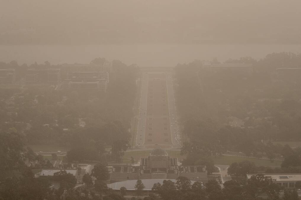 Wild winds dramatically reduced visibility in Canberra on Tuesday, blanketing Anzac Parade in dust.  Photo: Sitthixay Ditthavong
