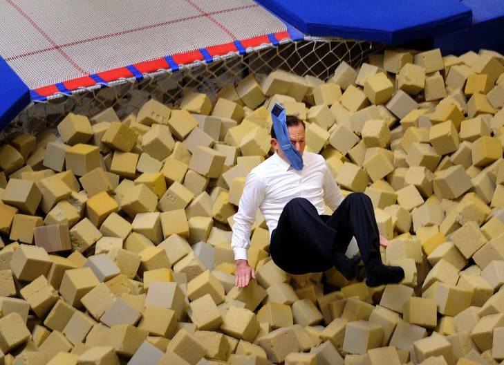 Opposition leader Tony Abbott jumps into the foam pit. Photo: Colleen Petch