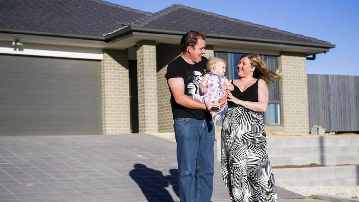 James Petterson, with his wife Sarah, and 16-month-old daughter Rachael, outside their home in Bonner. Photo: Rohan Thomson