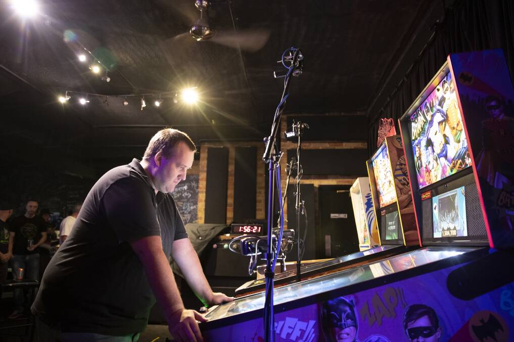 Richard Rhodes competes in the finals of the pinball championship at Belconnen. Photo: Sitthixay Ditthavong