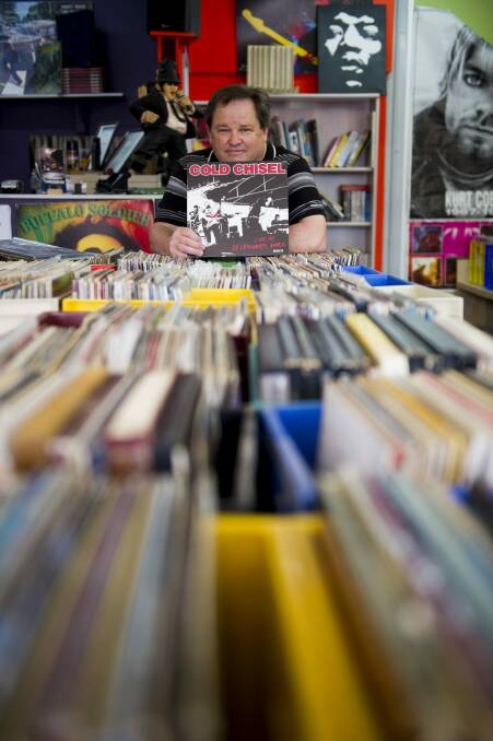 Dynomite Records owner Phil Place with some of the 8000-plus records in his Kambah store. Cold Chisel will release a vinyl box set  next month. 
 Photo: Jay Cronan