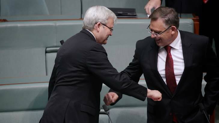 Labor MPs Kevin Rudd and Anthony Byrne greet each other with air-punches at the start of Question Time. Photo: Alex Ellinghausen