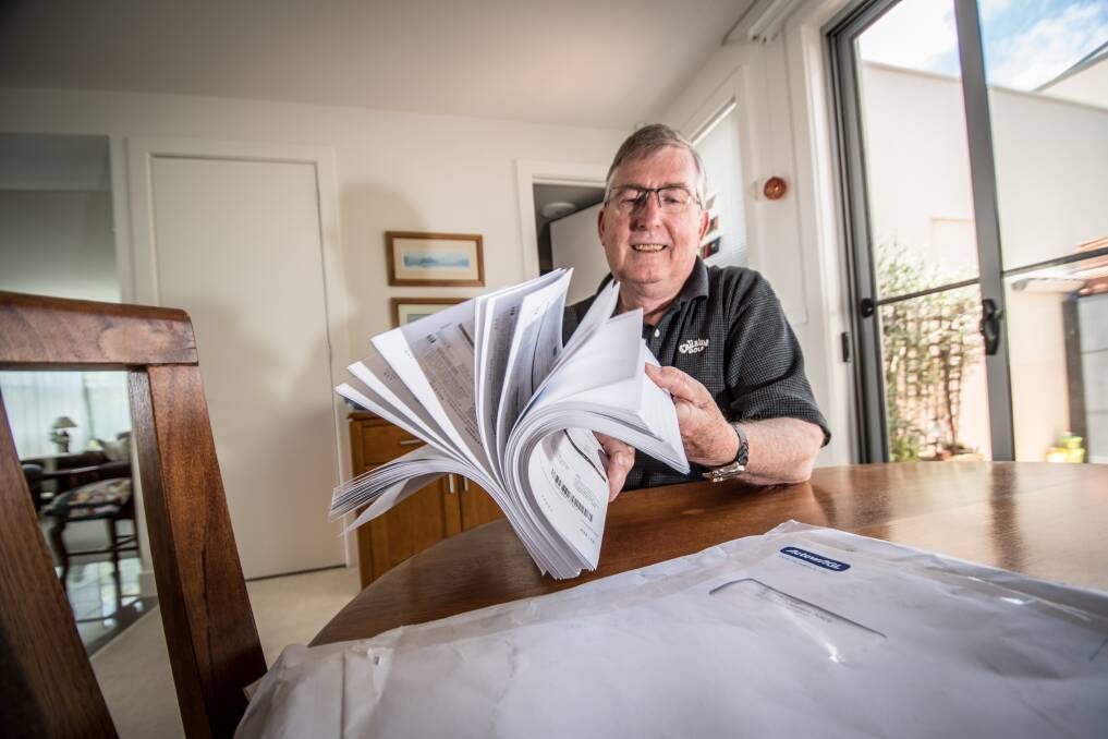 Belconnen resident John Steep, who received a parcel of hundreds of ActewAGL bills on Wednesday. Photo: Karleen Minney