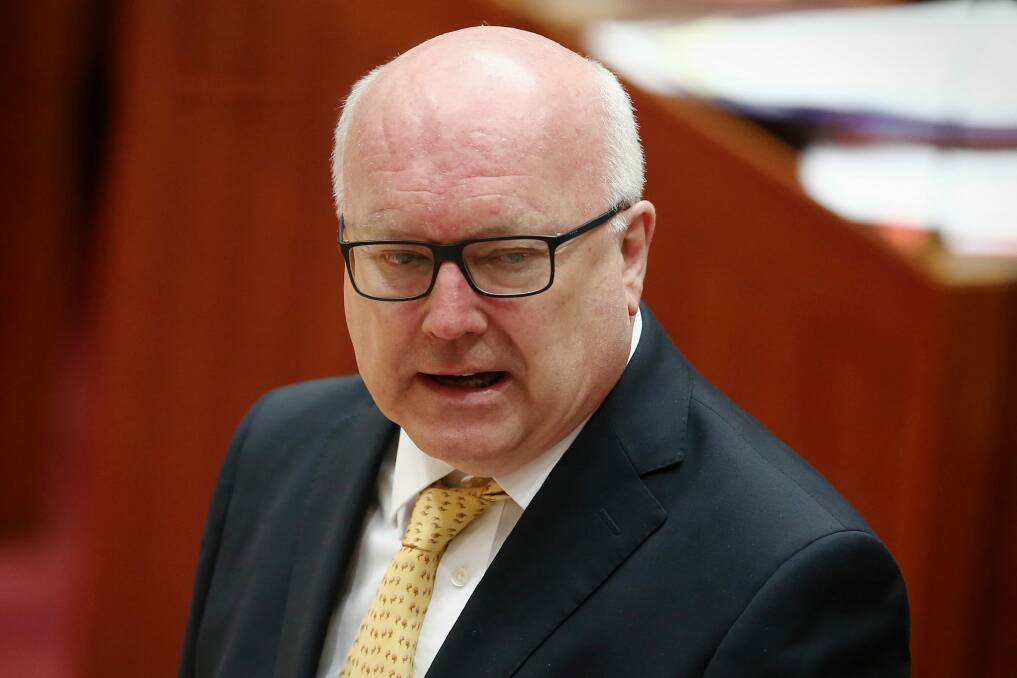 Attorney-General George Brandis will introduce new laws targeting foreign spies, agents and donations to parliament by the end of the year. Photo: Alex Ellinghausen