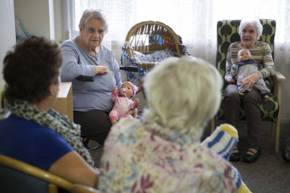 New hope: Mintie Hoskins (left) and Betty Wallace (right) participating in the the empathetic doll therapy program for dementia patients at the Uniting Mirinjani Weston. Photo: Matthew Bickerton