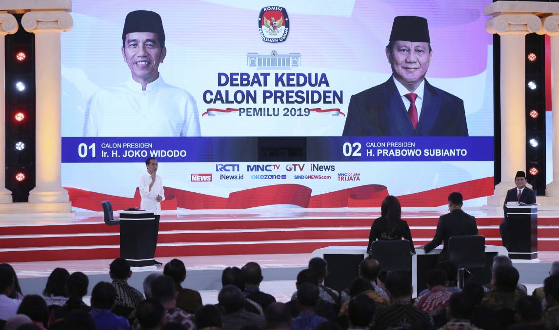 Indonesia's President Joko Widodo (left) delivers his speech as opponent Prabowo Subianto listens during the televised debate in Jakarta on Sunday night. Photo: AP