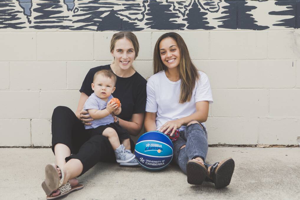Mikaela Dombkins and her partner Canberra Capitals guard Leilani Mitchell with their son Kash Mitchell-Dombkins. Photo: Jamila Toderas