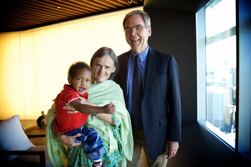 Valerie Browning with her adopted son Nabil, two, and her brother, retired Anglican Bishop of Canberra and Goulburn George Browning. They come from a family of eight siblings, all dedicated to giving back. Photo: Wolter Peeters
