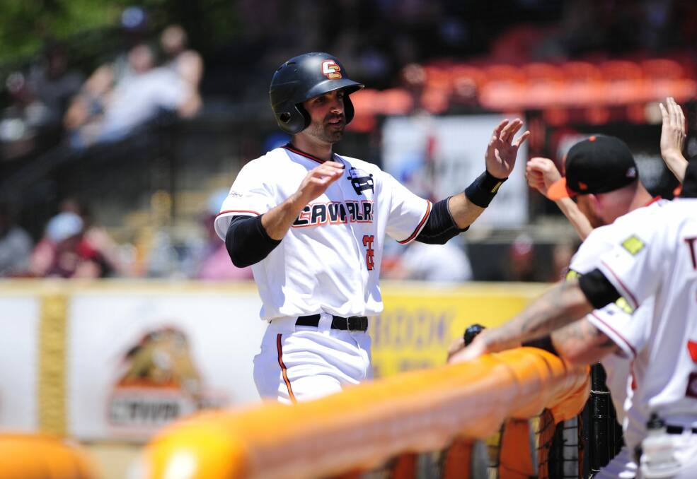 Canberra Cavalry player Jason Leblebijian celebrates with teammates after scoring a run in Sunday's 12-7 win against Adelaide. Photo: Melissa Adams