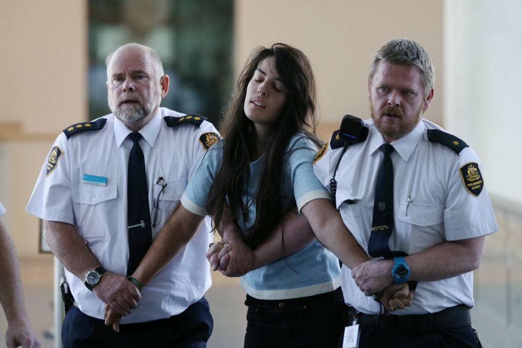 Protestors are escorted from Parliament House in Canberra on Wednesday. Photo: Andrew Meares