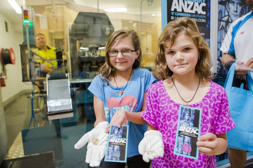 Sisters Emalee Olbrich (left), 11, and Chelsea Olbrich, 8, travelled to Canberra from Sydney to receive one of the first coins minted at the Royal Australian Mint for 2015. Photo: JAMILA TODERAS