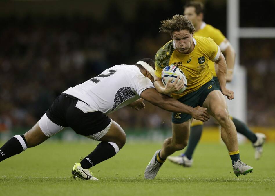 Australia's Michael Hooper is tackled by Fiji's Talemaitoga Tuapati. Photo: AP
