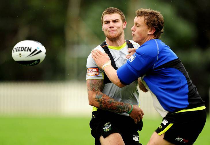 The Canberra Raiders train at the club's headquarters in Bruce, Canberra. Josh Dugan gets a pass away under pressure from Jake Wighton. Photo: Stuart Walmsley
