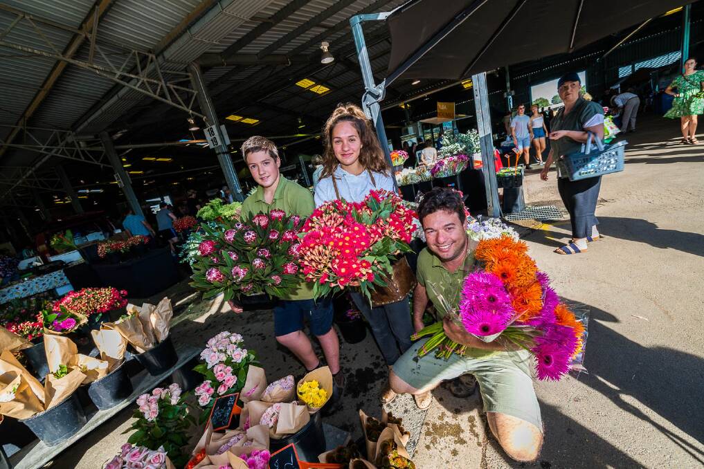 Luca, Nicola and John Padovano from Jonima Flowers. The children have grown up at the markets. Photo: Paul Chapman