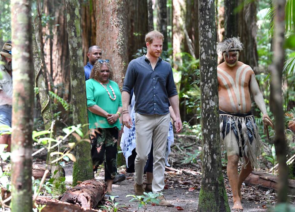 Prince Harry is guided through the forest by Butchulla locals. Photo: AAP