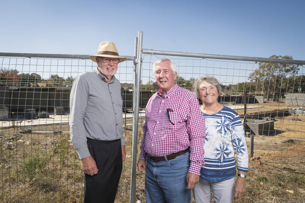 Giralang Residents Action Group members Bill Burmester and Ross and Olga Calvert, at the site of the old Giralang shops in April. Photo: Sitthixay Ditthavong