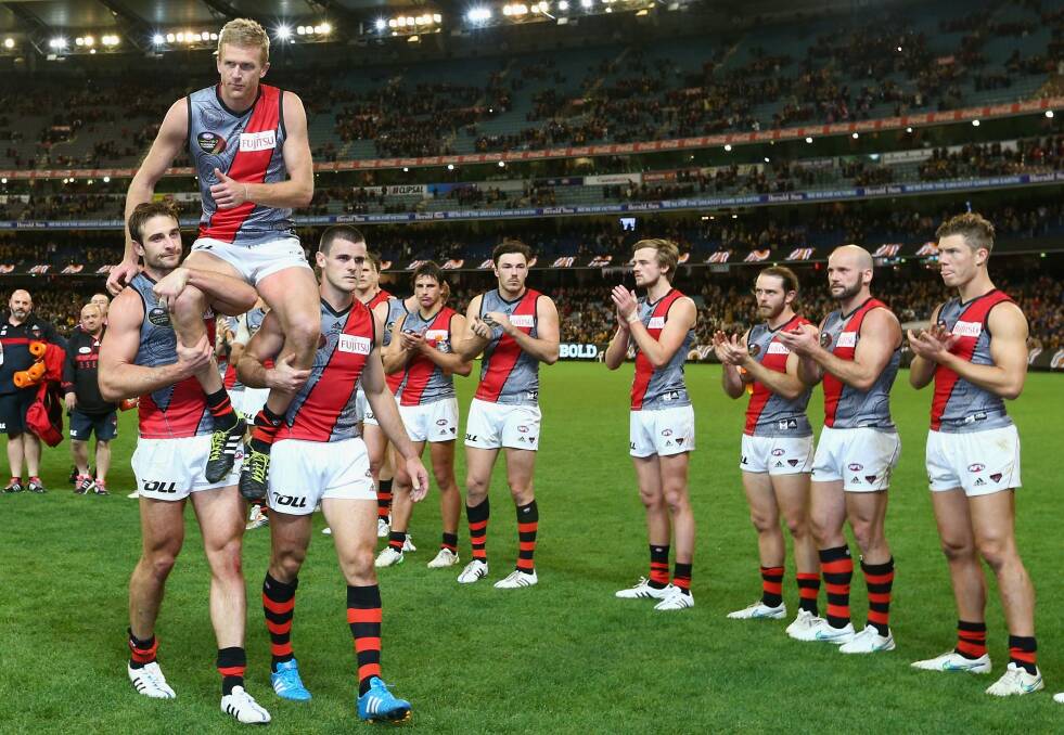 Dustin Fletcher of the Bombers is chaired off the ground after his 400th game. Photo: Getty Images