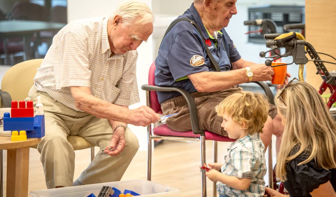 Participants of Intergenerational Playgroup, a scheme where residents of the Miranjani retirement village interact with kids from a local playgroup on a weekly basis to boost mental health and physical health.  Ex-pilot Ken Huttan (left) and Ron Dean (right) regularly play aeroplanes with three year old Archie Tunningley.  Photo: Karleen Minney