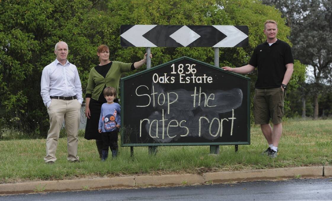 Oaks Estate residents are unhappy with the ACT government over their rates and services. From left, Pablo Serazio, Kate Gauthier, her son Luther Griffin, 4, and Adam Stokes. Photo: Graham Tidy