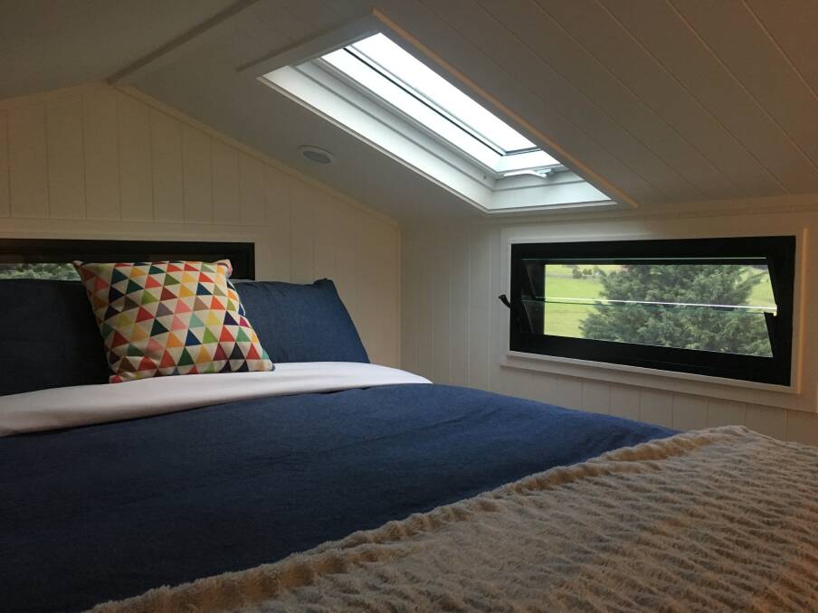 Loft bedroom, complete with skylight roof window at Clyde, one of Tilba Lake Camp’s two tiny houses. Photo: Tim the Yowie Man