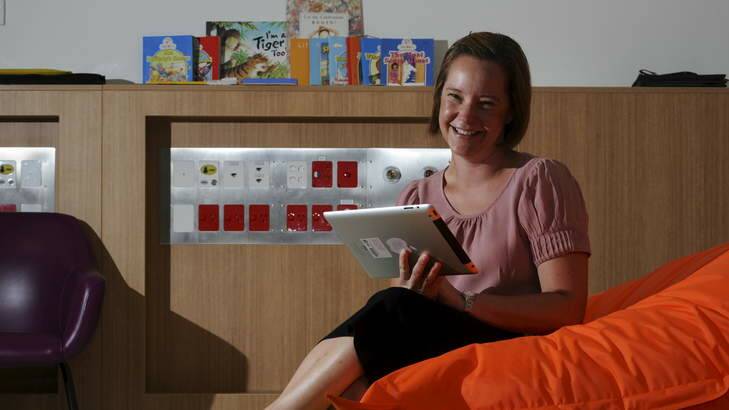 Assistant Director of Paediatrics at The Canberra Hospital, Katie McKenzie, reads her favourite books on her iPad. Photo: Graham Tidy