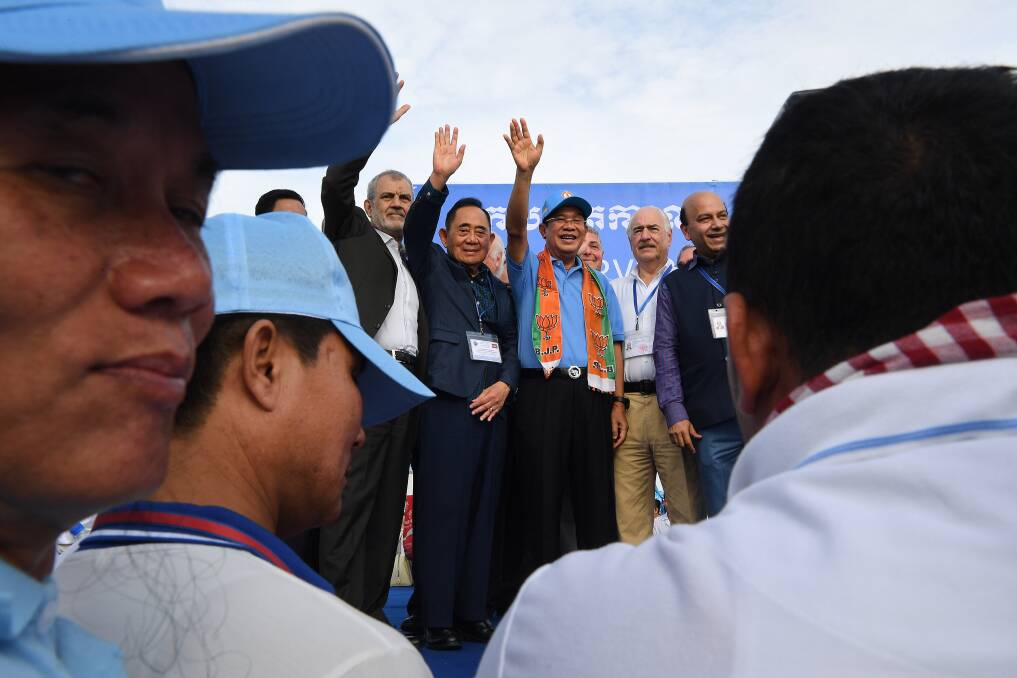 Cambodian PM Hun Sen, right, stands with the International election observers. Photo: Kate Geraghty