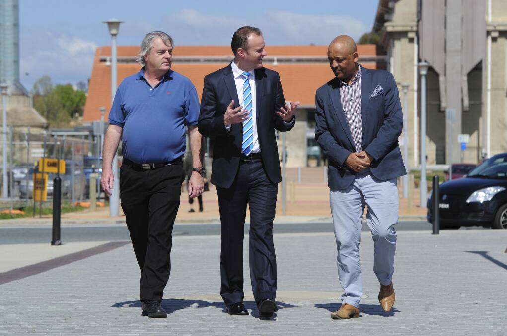 Signed up: Chief Minister Andrew Barr talks with future Uber drivers Gary Woodbridge and Teferi Gungl.
 Photo: Graham Tidy