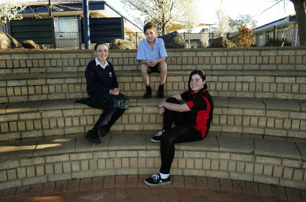 Year 6 students (from left) Lyara McCarron from Trinity Christian School, Matthew Cannon from St Jude's Primary School and Bella Connellan from Mount Rogers Primary School have been nominated for the ACT Fred Hollows Humanity Award. Photo: Melissa Adams