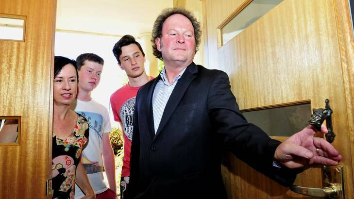 Liz Tilley and husband John Flannery with Conor Flannery, 15 and Patrick Flannery, 17 of Duffy were only able to salvage their door knocker from the 2003 Canberra Bushfires. Photo: Melissa Adams