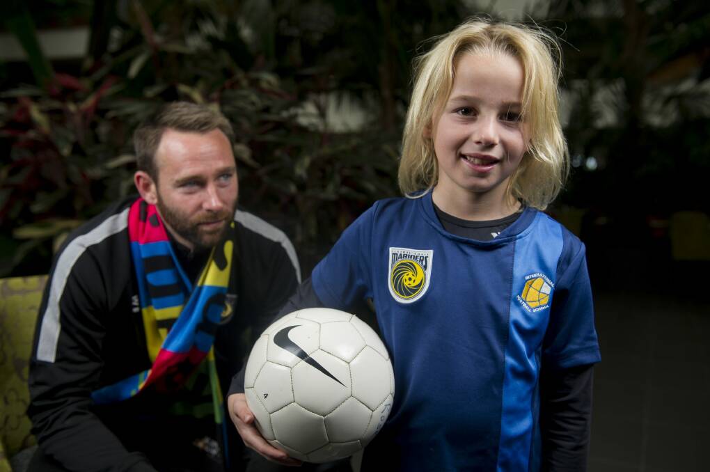 Central Coast Mariners' Josh Rose with his son Jai, who is playing in the Kanga Cup in Canberra. Photo: Jay Cronan