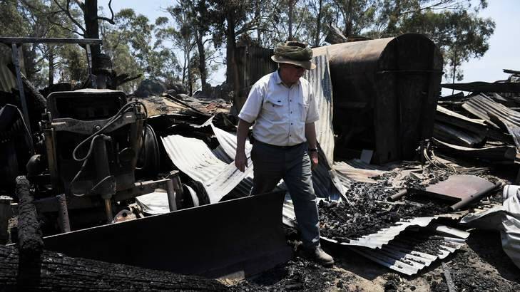 AFTERMATH: Ederveen owner Tom Webster sifts through his burnt-out equipment. Photo: Jay Cronan