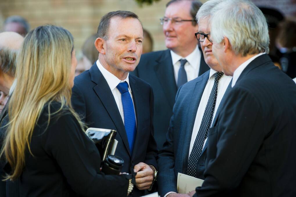 Former prime minister Tony Abbott was among those paying their respects at the funeral. Photo: Sitthixay Ditthavong