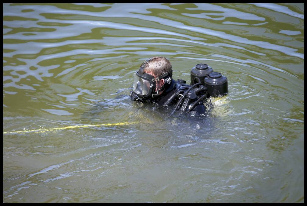 A police diver in the Maribynong River in February. Photo: Simon O'Dwyer