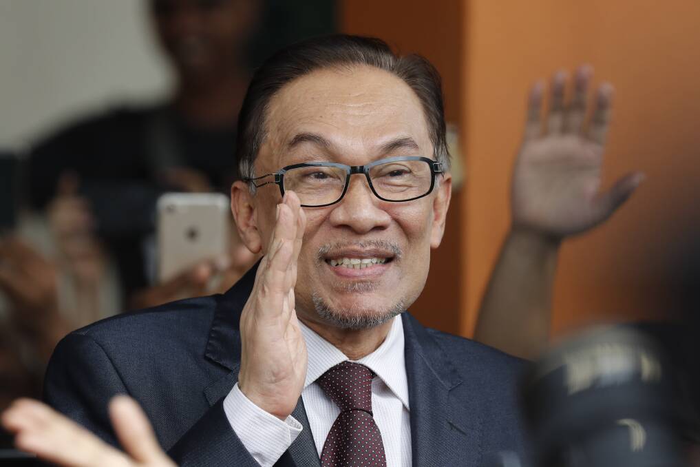 Anwar waves to supporters after his release Photo: AP
