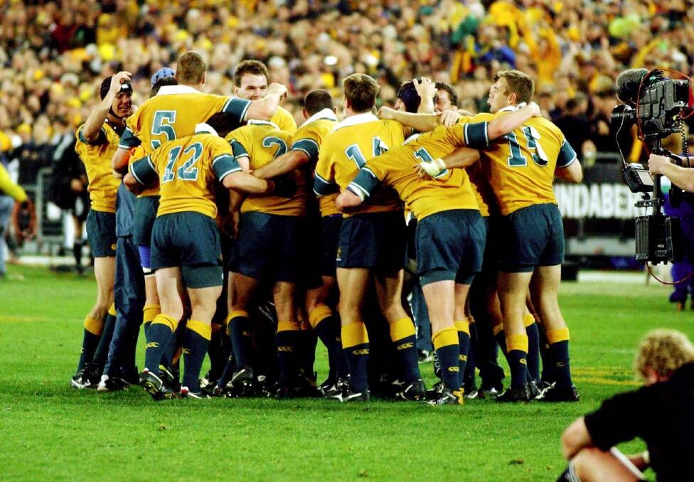 Long time between drinks: The Wallabies huddle together after that 2002 triumph. Photo: Mick Tsikas
