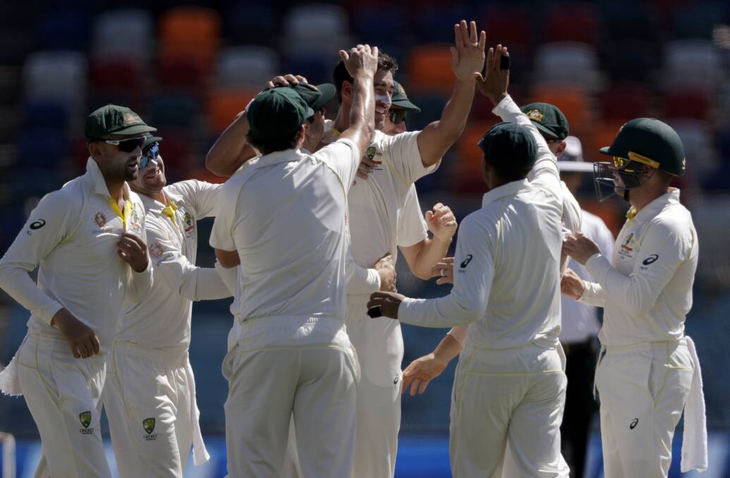 Mitchell Starc is congratulated after one of his breakthroughs this morning. Photo: AP