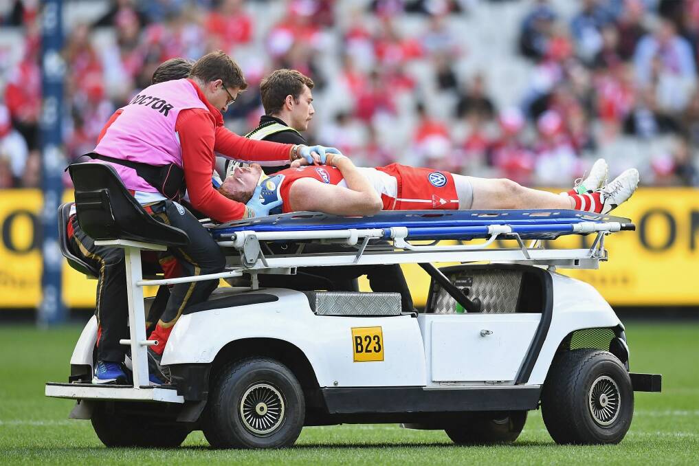 Gary Rohan is taken off on a stretcher after being knocked out. Photo: Getty Images