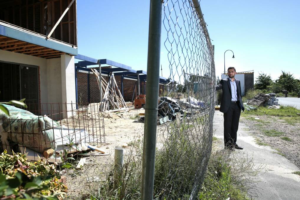 Goran Josifovski in front of one of the 11 vacant blocks. This site, opposite a park, is not secured and has building material blocking the footpath.   Photo: Jeffrey Chan.